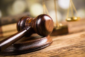 Golden scales of justice, books, Statue of Lady Justice. Owl and paragraph